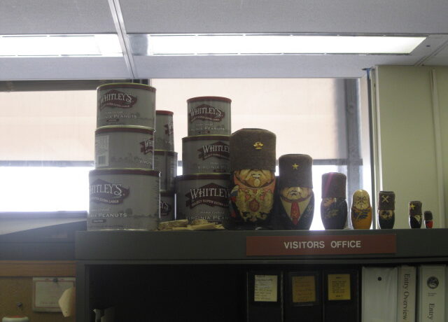 A stack of peanuts containers sits on a shelf
