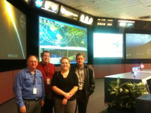 The team poses for a photo in mission control