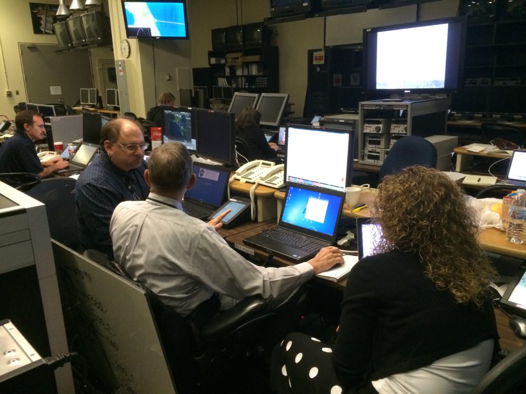 The team deep in discussion in mission control