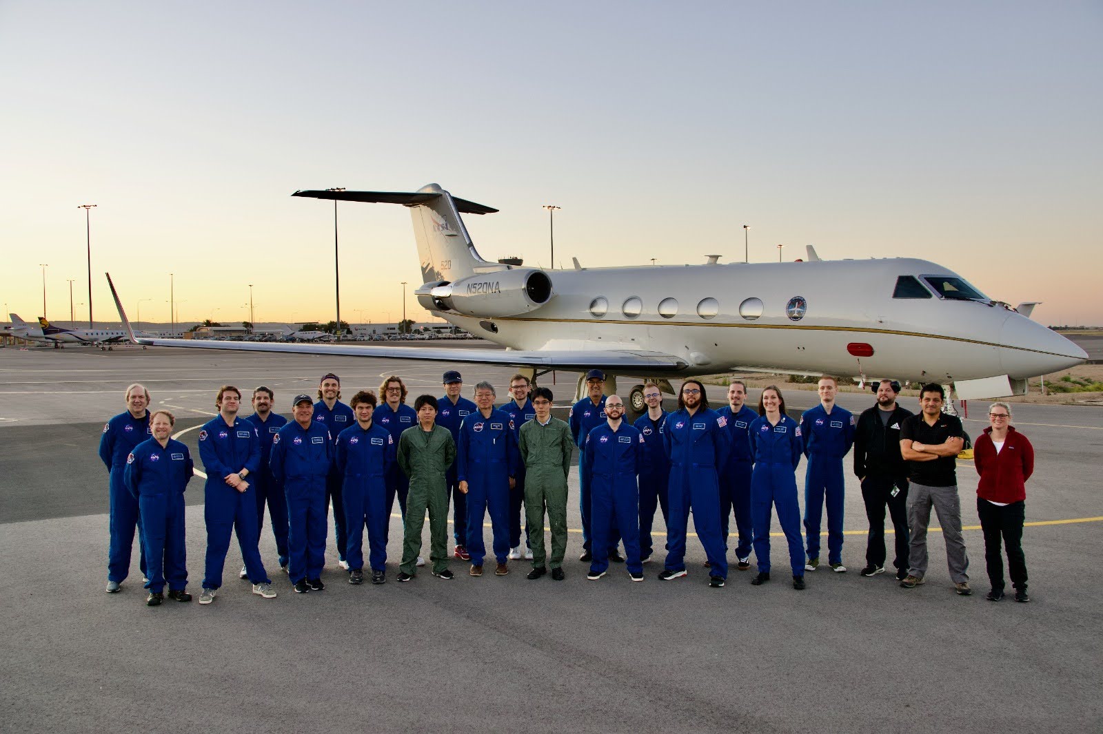 The Hayabusa 2 team in front of the mission's jet.