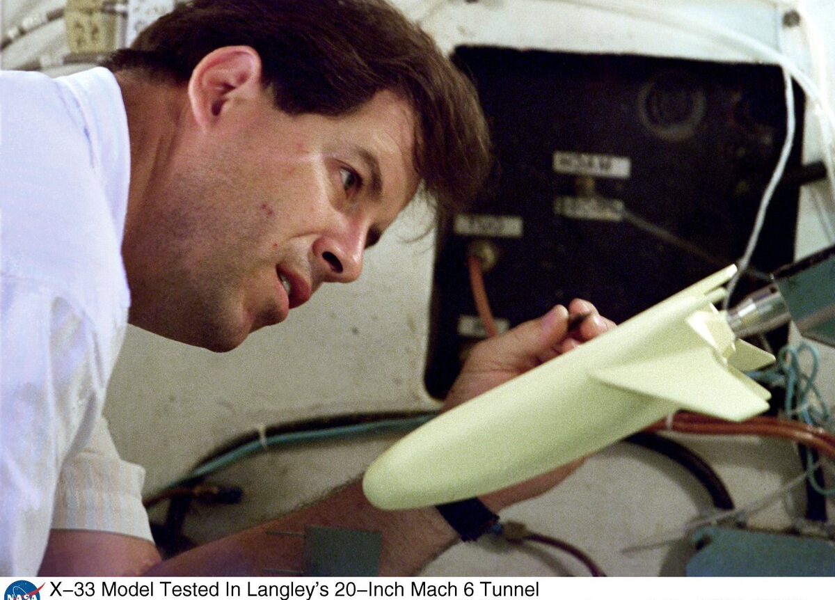 Thomas Horvath carefully examines a small wind-tunnel model.