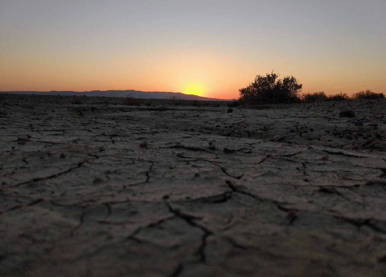 A vibrant sunset over a desert landscape