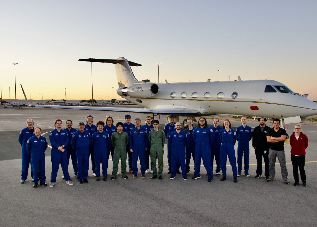 The Hayabusa 2 team in front of a jet